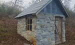 The farm's springhouse has been completely restored, even beyond its former glory.