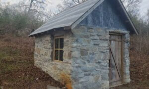 The farm's springhouse has been completely restored, even beyond its former glory.
