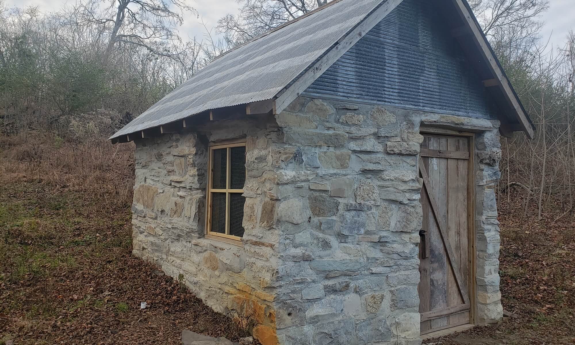 The farm's springhouse has been completely restored, even beyond its former glory.